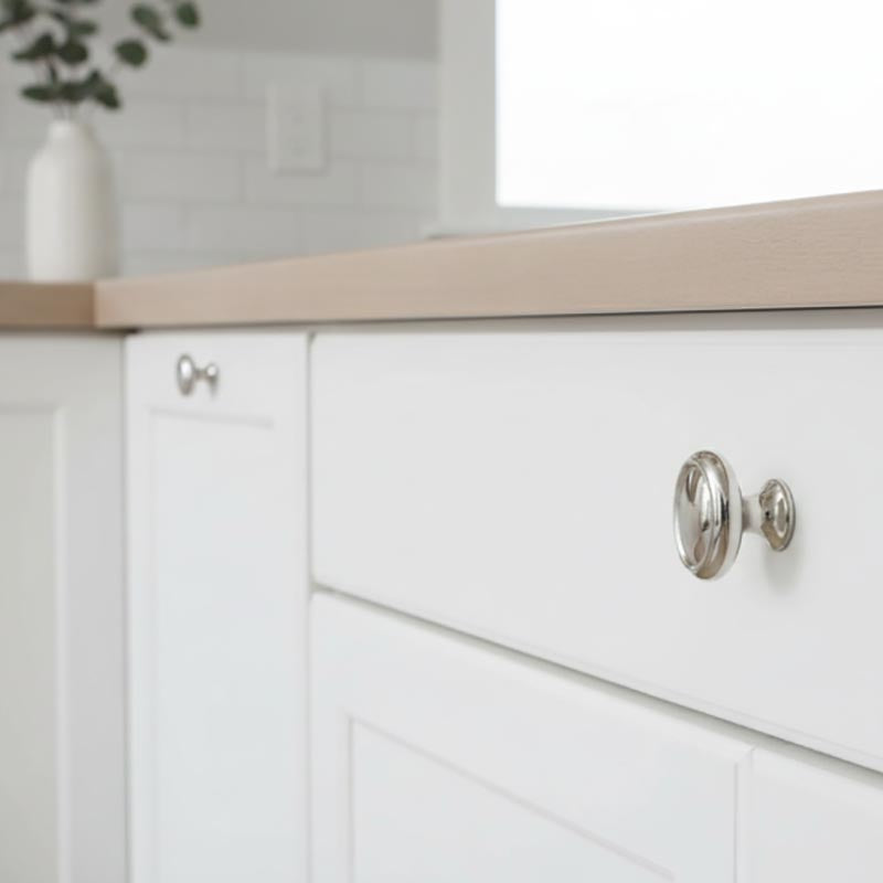 Contemporary Nickle Knob shown on white cabinets - Paxton Hardware